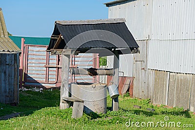 Old well of concrete rings in the courtyard Stock Photo