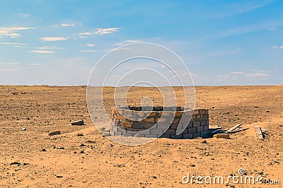 Old well in semi-desert Stock Photo