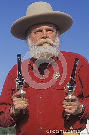 Old West gunslinger drawing guns Editorial Stock Photo