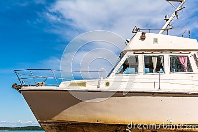 Old white boat shot sidewise against blue sky Stock Photo