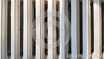 Old white cast-iron heating radiator in grunge style close-up Stock Photo