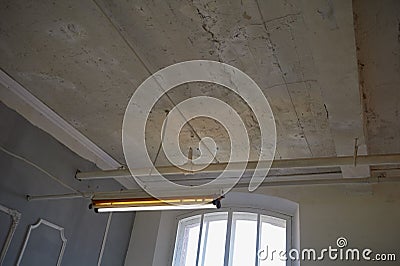 The old white ceiling in the production factory building with overhead fluorescent lights Stock Photo