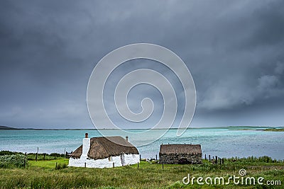 Traditionally built white croft cottage with thatched roof Stock Photo