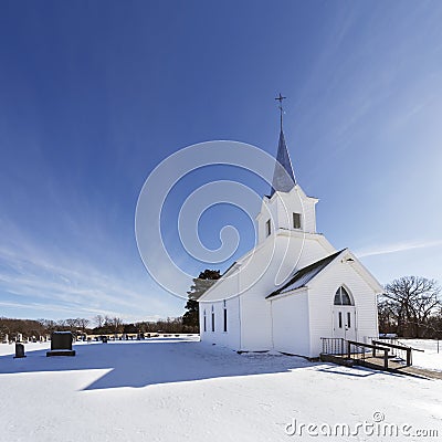 Old white country church in the snow. Stock Photo