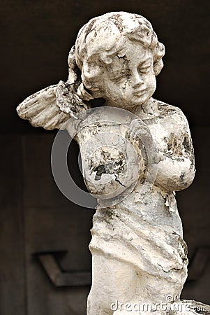 An Old White Crumbling Cherub Angel Statue Stock Photo