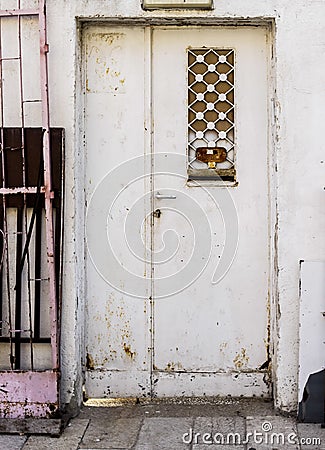 Old white durty, dirty door with rusty and openwork a beautiful vintage background Stock Photo