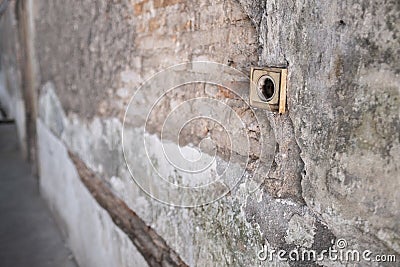 Cracked Concrete Vintage Wall with Electric Soket as the Foreground. Stock Photo