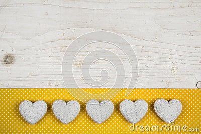 Old white shabby chic background with five hearts and yellow fab Stock Photo