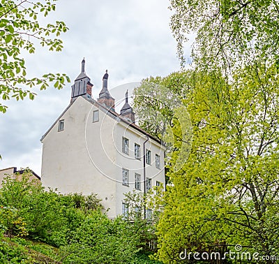 Old white three floor building in a green area in central Stockholm Editorial Stock Photo