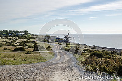 Old windmill by the coast Stock Photo