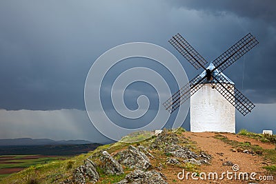 Old Windmill on dramatic sky and rain Stock Photo