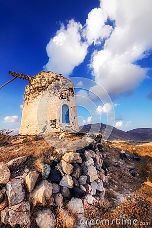 Old windmill ruins on a hill in Santorini island Stock Photo