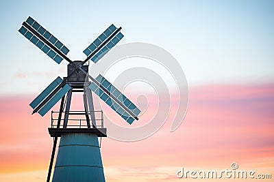 old windmill silhouette against dawn sky Stock Photo