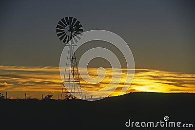 Old windmill at sunset Stock Photo