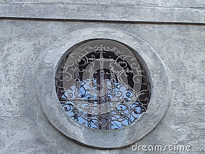 Old window with little vitrage design in old building. Landscape architecture. Stock Photo