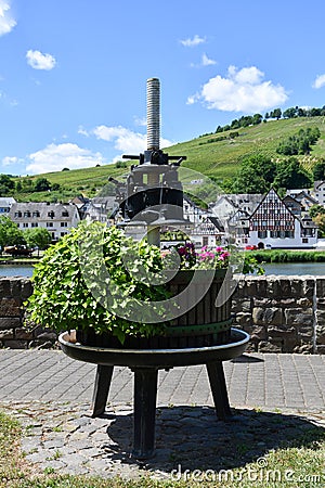 An old wine press decorated with flowers Stock Photo