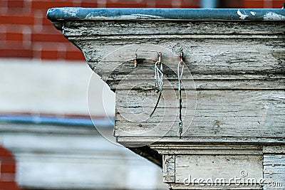 Old wire hooked on an old timber wall detail Stock Photo