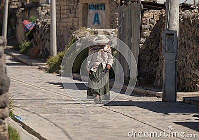 Old woman in andes town village Achoma wearing traditional indigenous handwoven colorful dress costume Colca Canyon Peru Editorial Stock Photo