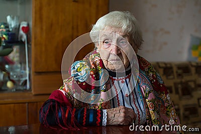 An old woman in bright ethnic clothes and a scarf Stock Photo