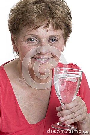 Old woman drinking glass of a mineral water Stock Photo