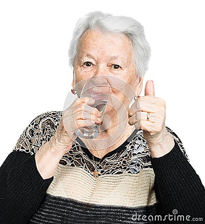 Old woman with glass of water Stock Photo