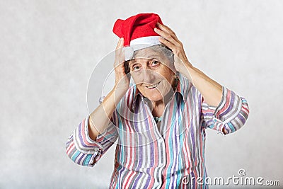 Old woman in the hat of a santa claus Stock Photo