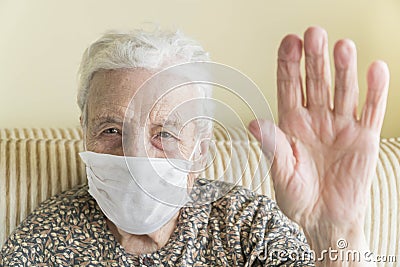 Old woman with health mask making stop sign with wrinkled hand Stock Photo