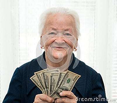 Old woman holding money in hands Stock Photo