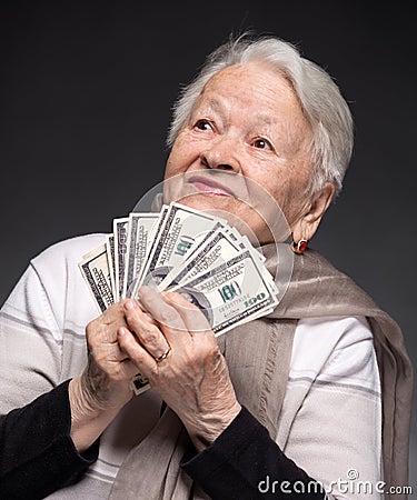 Old woman holding money in hands Stock Photo