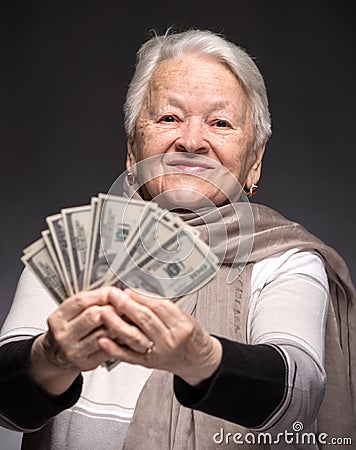 Old woman holding money in hands Stock Photo