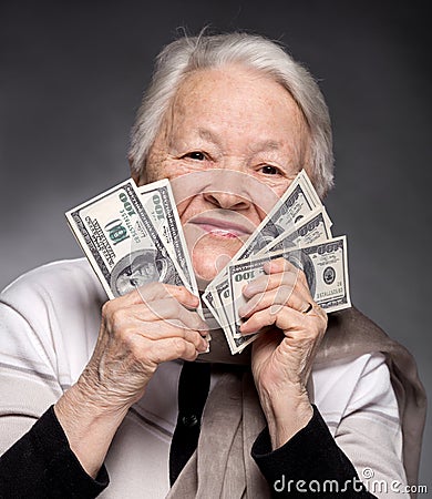 Old woman holding money in hands Stock Photo