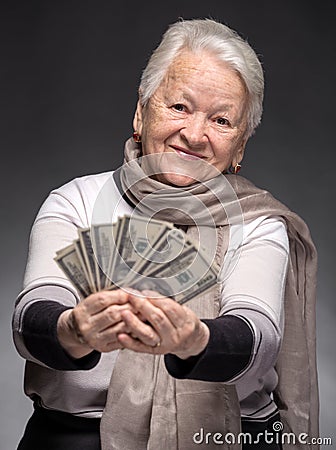 Old woman holding money in hands Stock Photo