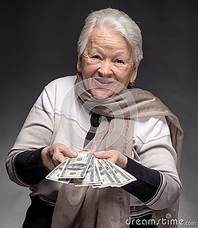 Old woman holding money in hands Stock Photo