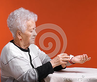 Old woman measures arterial pressure Stock Photo