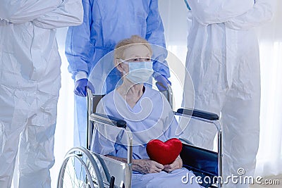 Old woman patient hold mini heart on a wheelchair Stock Photo