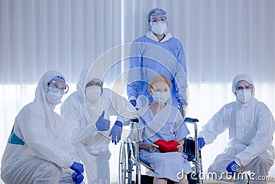 Old woman patient hold mini heart on a wheelchair Stock Photo