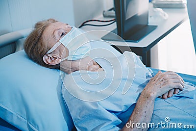 Old woman patient hold mini heart on a wheelchair Stock Photo