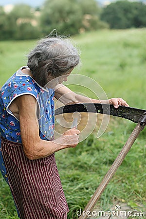 Old woman with the scythe Stock Photo