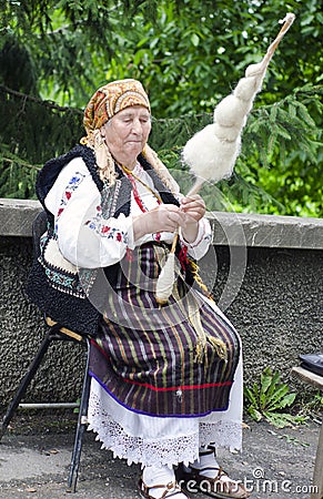 Old woman spinning wool Editorial Stock Photo