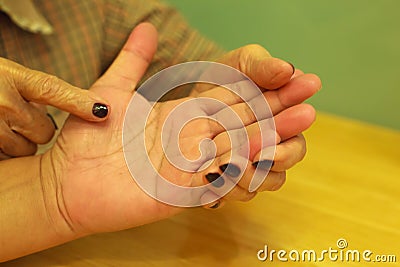 Old woman telling fortune for young man through Palm reading. Palm Reading, Palmistry Concept Stock Photo