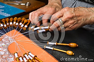 Old woman working on bobbin lace Stock Photo