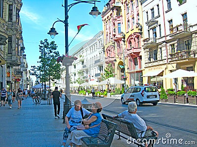 Old women conversing sitting on bench in day in city of Lodz Editorial Stock Photo