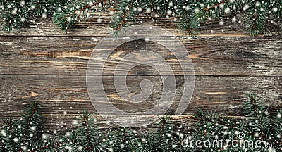 Old wood background with fir branches. Space for a greeting message. Christmas card. Top view. Effect snowflakes Stock Photo