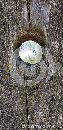 Old wood fencepost with hole Stock Photo