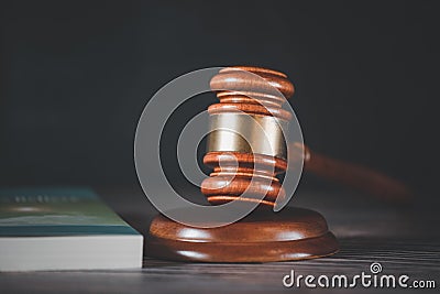 Old wood Judge Hammer with Law Book on the table wood background, Used for adjudication and Justice Stock Photo