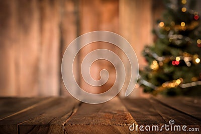 Old wood table top with blur Christmas tree in background Stock Photo