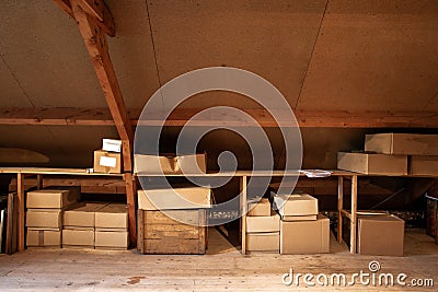 Old wooden attic interior with old cardboard boxes for storage or moving Stock Photo