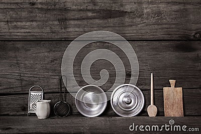 Old wooden background with miniatures of kitchen utensils like p Stock Photo