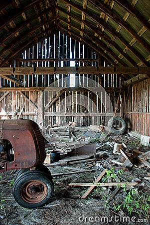 old wooden barn full of junk and rusting tractor royalty