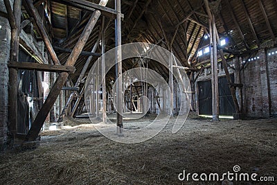 Old wooden barn with light shining through wooden boards Stock Photo